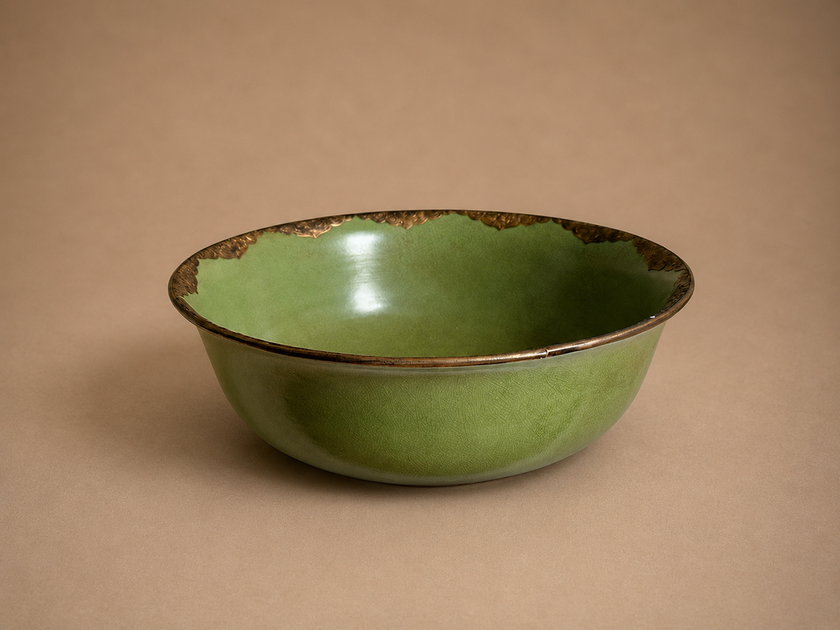 Large green ceramic bowl with bronze detail